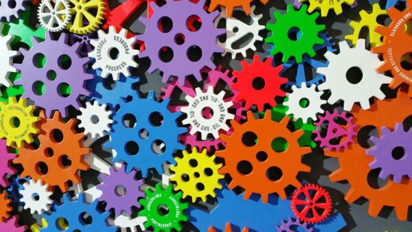 A mix of cogs in different colours, including purple, orange, yellow, red and white. productivity software